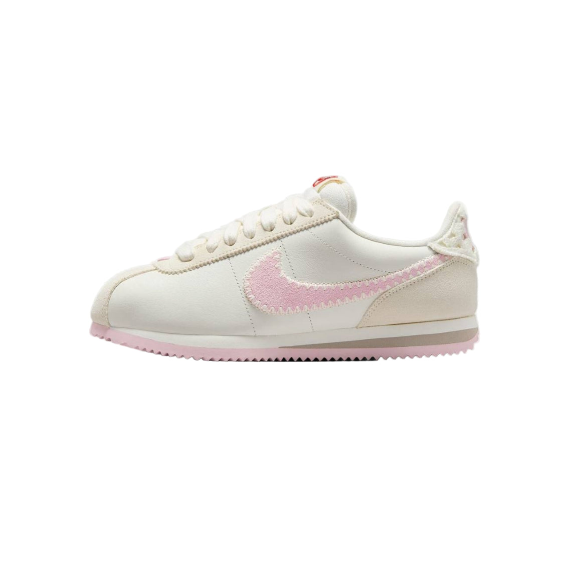 White sneaker with pink swoosh logo on a white background