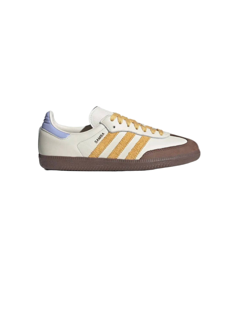 White sneaker with yellow accents on a white background