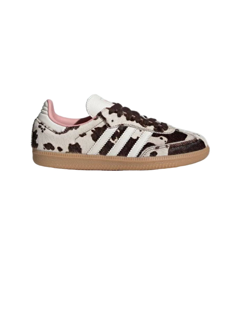 Cow print sneaker with pink interior on a white background