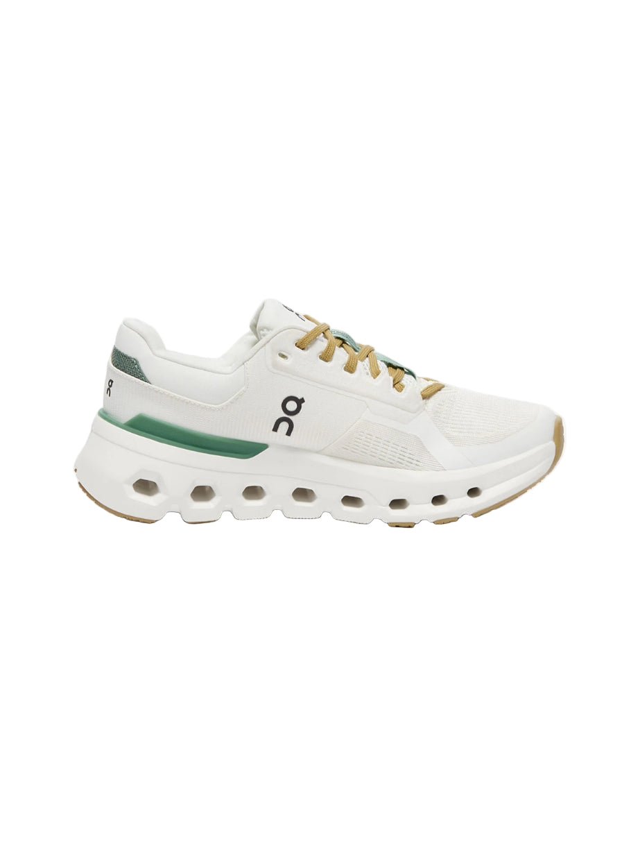 White sneaker with green accents on a white background