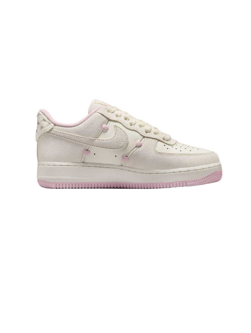 White sneaker with pink accents on a pink background