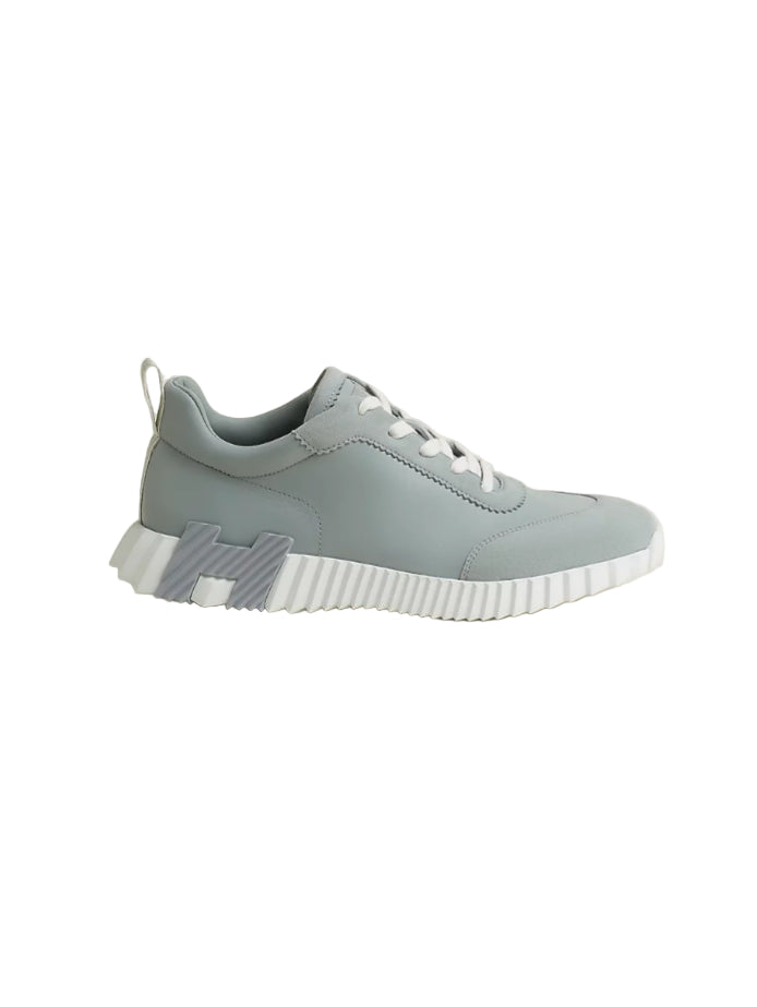Gray sneaker with white sole on a beige background