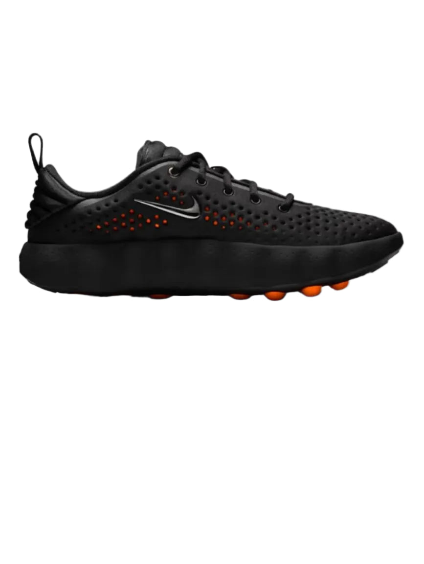 Black athletic shoe with orange accents on a white background